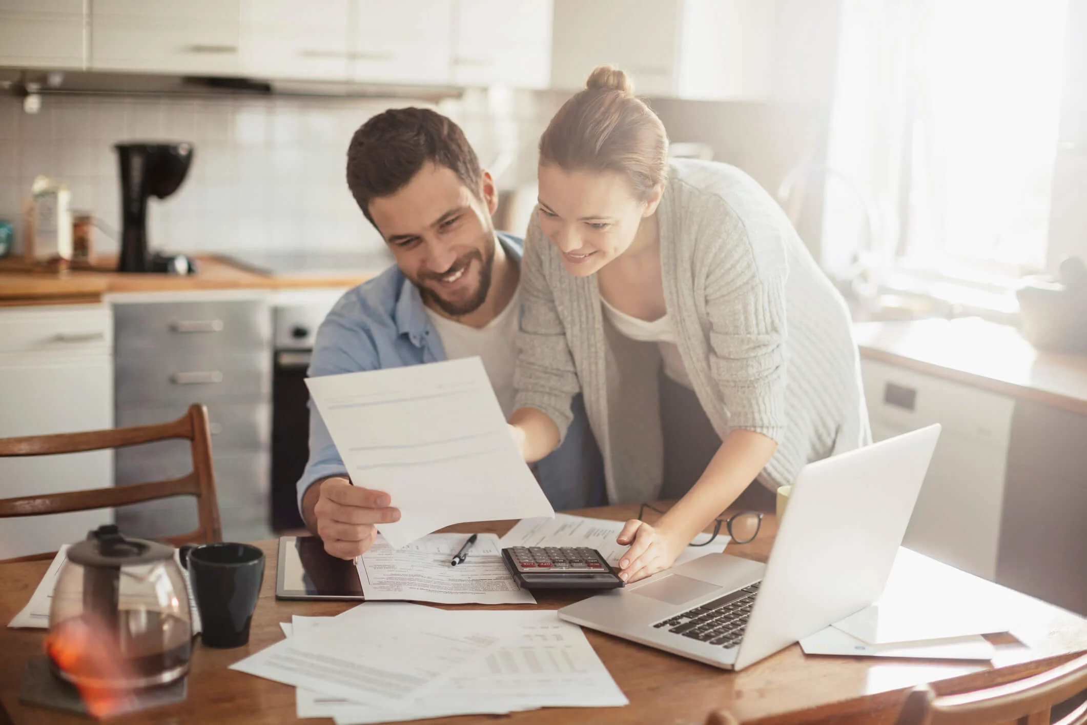This is a photo of a white couple going over some paper work and seeign that you dont need proof of income to get a title loan